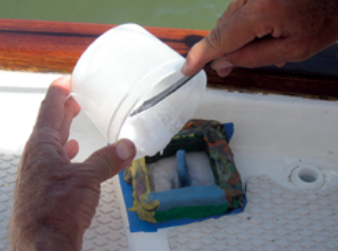 A mold of modeling clay defines the shape of an island of epoxy.