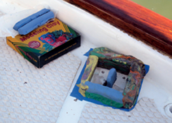 A mold of modeling clay defines the shape of an island of epoxy.
