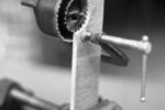 One clever way to enlarge a hole — without having an existing center for your hole saw — is the saw-within-a-saw trick, illustrated here in cutaway view.