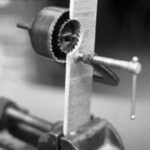 One clever way to enlarge a hole — without having an existing center for your hole saw — is the saw-within-a-saw trick, illustrated here in cutaway view.