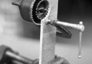 One clever way to enlarge a hole — without having an existing center for your hole saw — is the saw-within-a-saw trick, illustrated here in cutaway view.