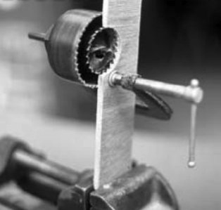 One clever way to enlarge a hole — without having an existing center for your hole saw — is the saw-within-a-saw trick, illustrated here in cutaway view.