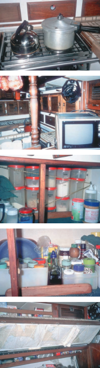 The two-burner stove is adequate for most meals, particularly when pressure cooking is involved, since the pressure cooker doesn’t need to sit on a burner all the time, top photo. The cooling blast from a little Helo fan can be aimed into the galley or the main cabin, second photo. Galley stowage using Tupperware and plastic, next two photos. Chart storage underneath the settee backs, bottom photo. Shelves for canned goods are also situated behind the settee backs.
