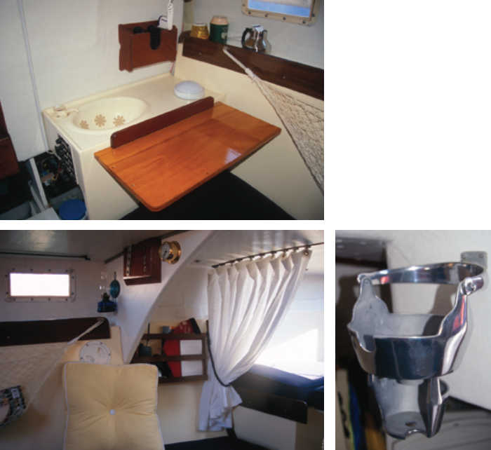 The galley doesn’t amount to much more than a small sink and a flip-up shelf for food preparation, at left. In an effort to save weight on Fatz, the bulkhead separating the V-berth has been replaced by a privacy curtain, bottom left. A portable toilet is beneath the V-berth. Because there isn’t sufficient galley space for a permanently mounted stovetop, the builder installed a single-burner Sea Swing stove next to the companionway, bottom right.
