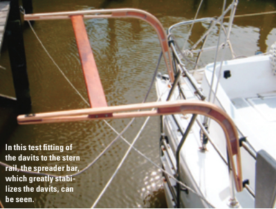 In this test fitting of the davits to the stern rail, the spreader bar, which greatly stabilizes the davits, can be seen.