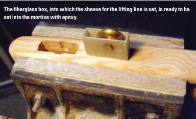 The fiberglass box, into which the sheave for the lifting line is set, is ready to be set into the mortise with epoxy.