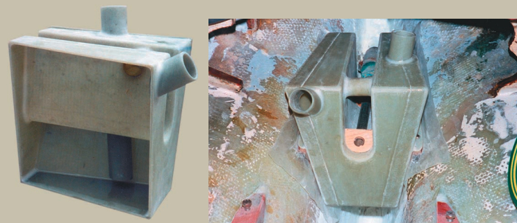 The waterlift muffler is complete, at left, except for adding the last side. The epoxy fillets used to strengthen the joints can be seen. Note that the outlet goes down almost to the bottom of the waterlift. Temporary plywood brackets were used to hang the waterlift in place, below, from the propeller shaft while epoxying the support stringers to the hull sides. Waxed paper was placed between the mounting brackets and the stringers to avoid gluing the waterlift to the hull. The fiberglass tape Paul used to strengthen the joints between the sides, top, bottom, and ends is easy to see also.