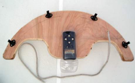 A view of the underside of the “boomerang” shows the clips with which it attaches to the bow pulpit and the “just in case” lanyard that keeps it there.