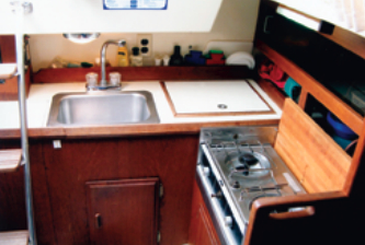 Liza’s galley, while small, has the necessities for meal preparation: stove, sink, icebox, and stowage.