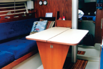The dining table on Liza folds up to the bulkhead when not in use, a nice feature for making room in a small cruiser.