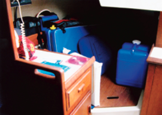 Liza’s quarter berth has been converted by David and Mary Lucas to bulk storage. The cabinet in front has a lift-up leaf that converts it to a small chart table.