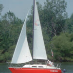 The sheer of the PY23 is very flat and from certain angles almost appears as reverse sheer. John Keeler, of Levittsburg, Ohio, sails Code Red, a 1979 model.