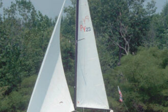 The sheer of the PY23 is very flat and from certain angles almost appears as reverse sheer. John Keeler, of Levittsburg, Ohio, sails Code Red, a 1979 model.