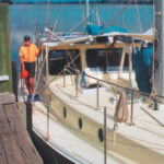 Author Alan Lucas aboard Soleares. Alan’s pilot rail can be seen on the cabintop. This convenient handhold adds safety for those moving about on deck, helps contain sails when they’re being furled, and is a great place for tying off any halyards not in use.