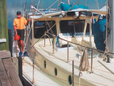 Author Alan Lucas aboard Soleares. Alan’s pilot rail can be seen on the cabintop. This convenient handhold adds safety for those moving about on deck, helps contain sails when they’re being furled, and is a great place for tying off any halyards not in use.
