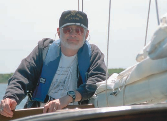 Picture of a man leaning on a boat
