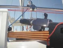 The tiller-mounted outboard-motor controls and the traveler.