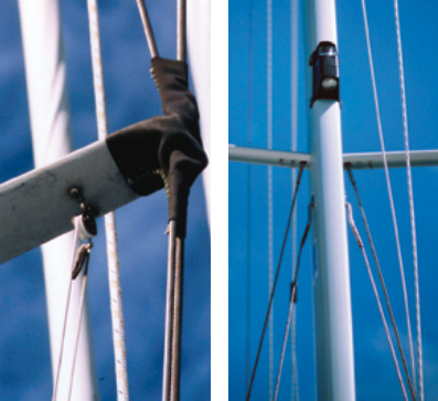 To service the spreader end, the leather spreader boot, above, will need to be removed and re-sewn. Note how the top forms a funnel to trap moisture and debris. Next time, the leather should be sewn around each wire individually. On the new boat, at right, recently delivered from the factory, the T-balls at the top of the lower shrouds do not line up with the angle of the wire. This will cause premature failure of the wire, as some strands will be taking more load than others.