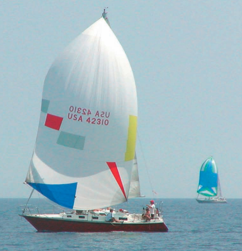 Payoff time after all the hard work: Strider sails beautifully. Strider’s chute is up for a light-air Tuesday-night race.