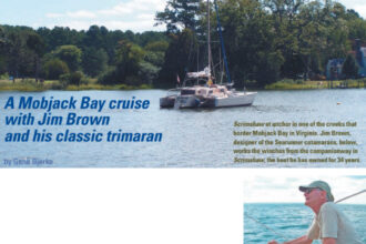 Scrimshaw at anchor in one of the creeks that border Mobjack Bay in Virginia. Jim Brown, designer of the Searunner catamarans, below, works the winches from the companionway in Scrimshaw, the boat he has owned for 34 years.