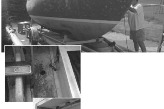 Jim sands and fills and sands and fills. The top photo was taken after the first week of sanding and filling. The original companionway steps and what remains of the original electrical panel, center. The aft port bulkhead, at right.