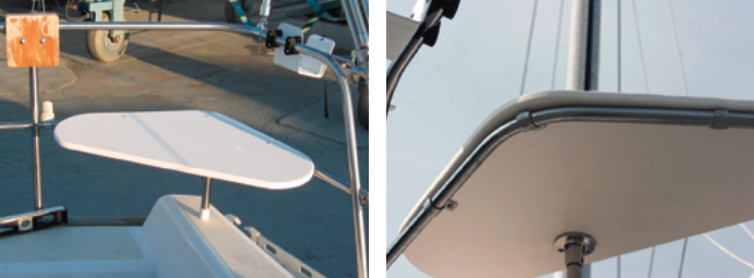The port side stern-rail seat is installed and ready for use, below left. The leg can be installed in different locations so that it fits on a variety of boats. The three barrel nuts that attach to the pipe clamps on the railing under the seat are barely visible. A builder’s level was used to make sure that the seat was level fore and aft and side to side. Stern-rail seat seen from the underside shows three clamps, one in the corner and one along each of the opposite sides, below right.