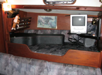 The pilot berth above the starboard settee belongs to Tom’s guitar. The ship’s dinghy, named Higher Puppus, belongs to Boomer, the ship’s mascot and security guard/boat dog.