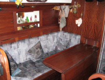 The dining area, along with the nav station (not shown) and the companionway ladder, offers seating for between 25 and 50 drunken sailors, or so it seems at parties on Higher Porpoise.