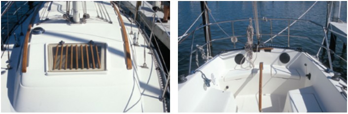 The forward hatch has teak strips over it to provide sure footing, at left. Mainsail sheeting is end-boom to a traveler across the transom, at right.