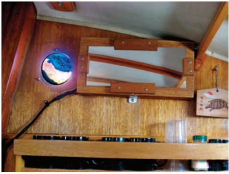 Stained glass portlight in an old instrument hole