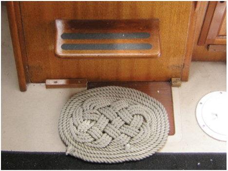 A handmade mat at the companionway ladder