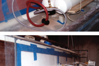 A sheet of strong poly is sealed to the area and a vacuum pump is used to supply an even clamping pressure.