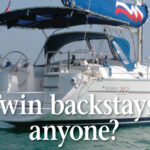 The walk-through transom and resulting split back- stay offered a neat solution for the owners of this Moorings 39.3. Their Bimini is laced to a tube attached to the backstay.