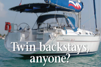 The walk-through transom and resulting split back- stay offered a neat solution for the owners of this Moorings 39.3. Their Bimini is laced to a tube attached to the backstay.