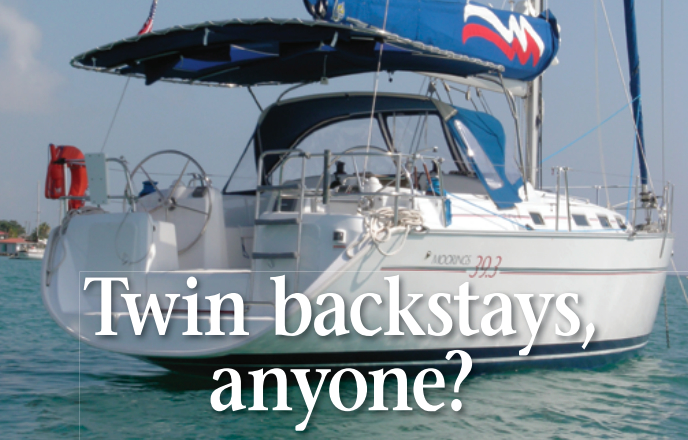 The walk-through transom and resulting split back- stay offered a neat solution for the owners of this Moorings 39.3. Their Bimini is laced to a tube attached to the backstay.