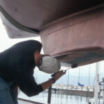 After your boat is in the slings, if your boatyard is a friendly one and you can be quick about it, apply paint in those areas that were previously inaccessible.