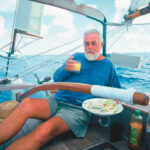 At sea, when fresh provisions tend to run short, Lin Pardey relies on cheeses for quick lunch solutions. A contented Larry Pardey, above, goes along with the plan.