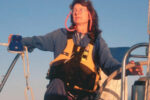 A woman steering a boat