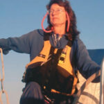 A woman steering a boat