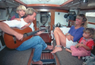 Cramped quarters? You bet. But Dave says coping with a small space is a mental challenge, not a physical one. Dave and Jaja relax with a tune during a quiet moment between the demands of two busy toddlers, at left.