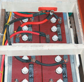 When we bought our Mason 43, the batteries were located beneath the V-berth, not exactly the best place to carry such weight. After removing the water heater, we were able to fit eight batteries beneath the cabin sole, right on the centerline between the mast and the engine.