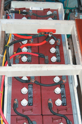 When we bought our Mason 43, the batteries were located beneath the V-berth, not exactly the best place to carry such weight. After removing the water heater, we were able to fit eight batteries beneath the cabin sole, right on the centerline between the mast and the engine.