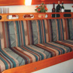 If there’s one thing that improves a boat during a refit, it’s a new set of cushion covers. Pat Brown figured this out in a hurry . . . and one thing more: to make it easy, staple the cloth to a plywood backing. This holds the cushion in place and sacrifices nothing in the way of comfort. It’s neat, trim, and fast.