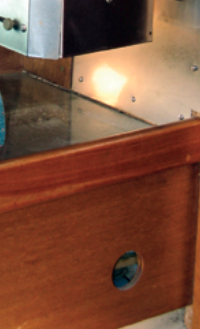 A vent hole under the stove and settee berth.