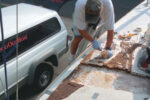 Picture of someone fixing the deck of a boat