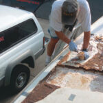 Picture of someone fixing the deck of a boat