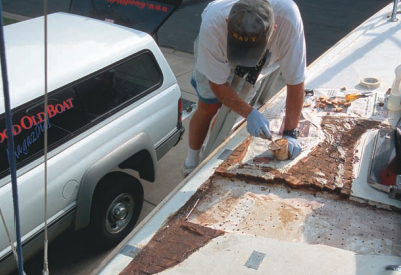 Picture of someone fixing the deck of a boat