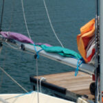 Mainsail frapped down using bungees. Lazy-jacks help.