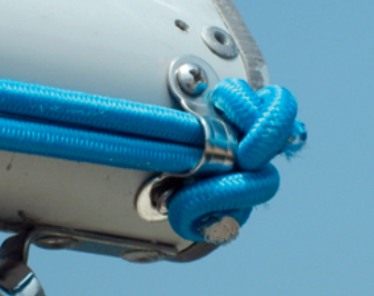 Aft end of boom showing the 5⁄16-inch eye strap securing two 1⁄4‐inch bungee ends. The arrangement is the same at the other end of the boom.