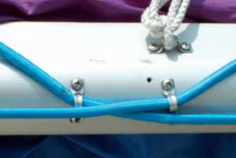 Port side of boom showing two 1⁄2-inch eye straps providing turning points for two bungees.
